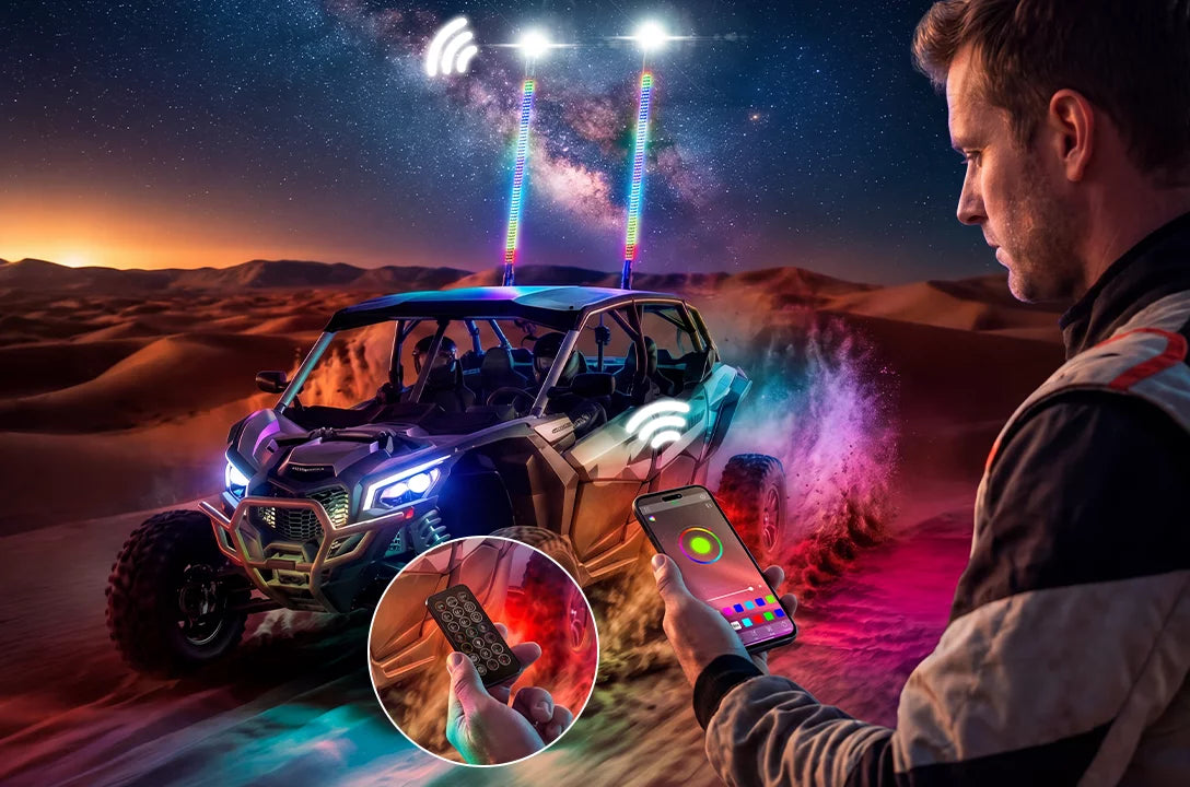 A man in a desert setting at night uses a smartphone app to control the lights on an off-road vehicle. The vehicle has colorful LED roof-mounted lights projecting beams into the night sky, with a circular inset showing a hand holding a remote control.