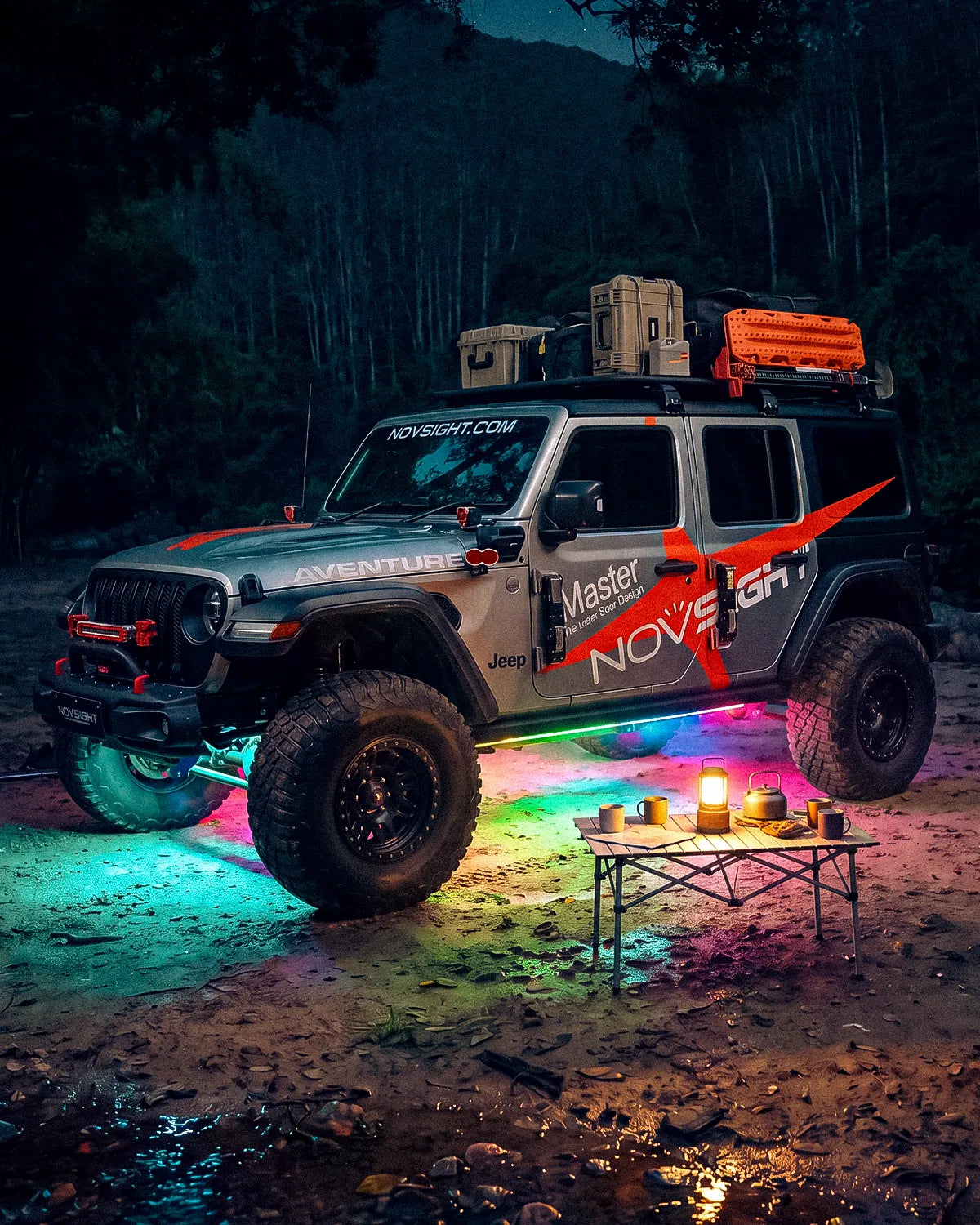 Jeep Wrangler at a campsite with RGB underglow lighting the ground 