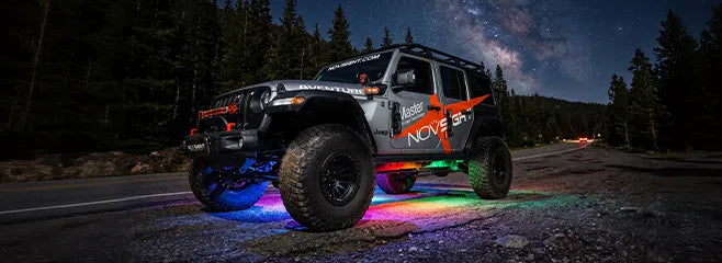 Jeep Wrangler on a night trail with RGB underglow lighting the ground