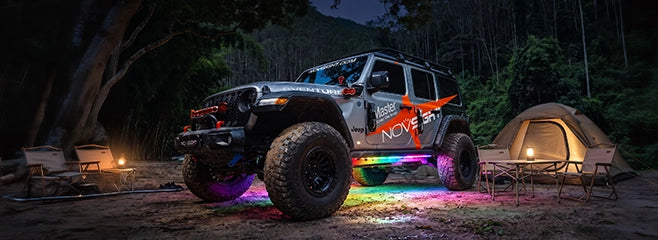 Jeep Wrangler at an overland campsite with underglow used as area lighting
